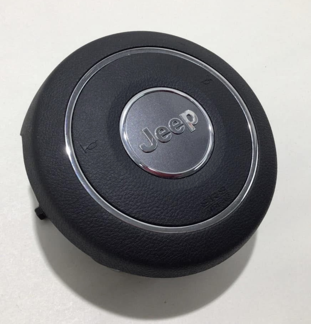 OEM Jeep Wrangler JK steering wheel airbag module.